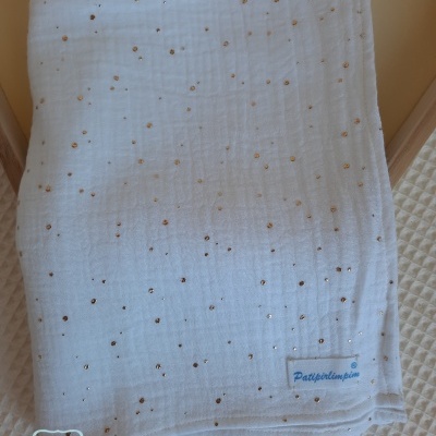 Fralda branca com pormenores dourados