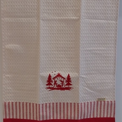 Pano de cozinha com presépio bordado.