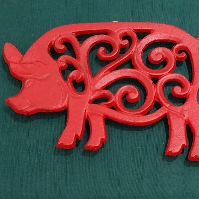 Base para quentes com a forma de um porco.