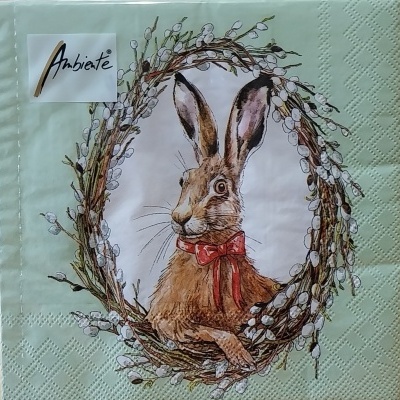 Guardanapos de papel com fundo verde claro e um coelho com um laço.